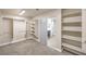Spacious walk-in closet with custom shelving, rods, and access to the bathroom at 260 Pioneers Peak, Henderson, NV 89002