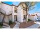 Two-story condo building featuring balconies, iron railings, earth-toned stucco, and desert landscaping at 2615 W Gary Ave # 1089, Las Vegas, NV 89123