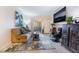A comfortable living room features a sofa, accent chair, and a large-screen television for entertainment at 2615 W Gary Ave # 1089, Las Vegas, NV 89123