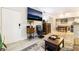 A modern living room features tile floors, access to the dining area, and a large-screen television at 2615 W Gary Ave # 1089, Las Vegas, NV 89123