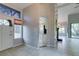 View of tiled foyer opening to kitchen and living room with natural light at 2714 Bridgepointe Dr, Las Vegas, NV 89121