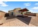 Backyard featuring a covered patio, rock landscaping, brick perimeter wall and a slider door at 2883 Mount Hope Dr, Las Vegas, NV 89156