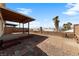 Spacious backyard with covered patio, brick accents, and desert landscaping, perfect for outdoor living at 2883 Mount Hope Dr, Las Vegas, NV 89156