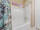 A bathtub with shower, tiled walls, and updated fixtures for a calming bath experience at 2883 Mount Hope Dr, Las Vegas, NV 89156