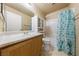 Bright bathroom featuring a vanity with marble countertop, a toilet, and a bathtub with shower at 2883 Mount Hope Dr, Las Vegas, NV 89156