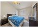 Bedroom with a window and dresser with neutral walls, bed, and a fan at 2883 Mount Hope Dr, Las Vegas, NV 89156