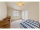 Bedroom with sloped ceiling, natural lighting, neutral carpet and boxes along wall at 2883 Mount Hope Dr, Las Vegas, NV 89156