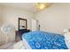 Neutral bedroom with ceiling fan, dresser, mirror, and blue snowflake blanket on bed at 2883 Mount Hope Dr, Las Vegas, NV 89156