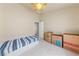 Minimalist bedroom with neutral walls, ceiling fan, and boxes near a twin size bed at 2883 Mount Hope Dr, Las Vegas, NV 89156