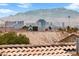 Unobstructed city view from this home featuring beautiful red tile roofing and the Las Vegas strip at 2883 Mount Hope Dr, Las Vegas, NV 89156