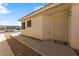 Home's front entrance features a secure door, desert landscaping, and a covered porch at 2883 Mount Hope Dr, Las Vegas, NV 89156