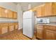 Spacious kitchen showcases ample wood cabinetry, a full-size white refrigerator, and sleek countertop appliances at 2883 Mount Hope Dr, Las Vegas, NV 89156