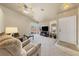Cozy living room featuring a ceiling fan, carpeted floors, and sliding glass doors to the backyard at 2883 Mount Hope Dr, Las Vegas, NV 89156