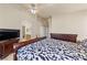 Spacious bedroom with dark wood furnishings and a walk-through to the primary ensuite bathroom at 2883 Mount Hope Dr, Las Vegas, NV 89156
