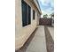 Side yard featuring a concrete walkway, desert landscaping, and a privacy wall at 2883 Mount Hope Dr, Las Vegas, NV 89156