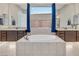 Relaxing bathroom showcasing a soaking tub, granite countertops, and dual vanities at 2931 Raywood Ash Dr, Las Vegas, NV 89138