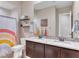 Charming bathroom showcasing dual sinks, decorative shelves, and colorful accents at 2931 Raywood Ash Dr, Las Vegas, NV 89138