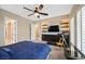 Comfortable bedroom featuring a ceiling fan, built-in shelves, and a modern entertainment area at 2931 Raywood Ash Dr, Las Vegas, NV 89138