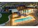 Stunning community pool area with palm trees, lounge chairs, and a modern clubhouse in a luxury setting at 2931 Raywood Ash Dr, Las Vegas, NV 89138