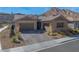 Charming single-story home with a three-car garage and desert landscaping at 2931 Raywood Ash Dr, Las Vegas, NV 89138