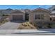 Attractive single-story house with stone accents, a three-car garage, and desert landscaping at 2931 Raywood Ash Dr, Las Vegas, NV 89138