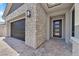 Welcoming front entrance with stone accents, a three-car garage, and a charming welcome mat at 2931 Raywood Ash Dr, Las Vegas, NV 89138