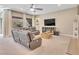 Bright living room with large sectional sofa, television, and backyard views at 2931 Raywood Ash Dr, Las Vegas, NV 89138