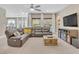 Bright living room boasts a large sectional sofa, fireplace, and backyard views at 2931 Raywood Ash Dr, Las Vegas, NV 89138