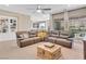 Open concept living room with backyard view, built-in shelving, and sectional sofa at 2931 Raywood Ash Dr, Las Vegas, NV 89138