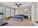 Comfortable primary bedroom with large windows, ceiling fan and private gym equipment at 2931 Raywood Ash Dr, Las Vegas, NV 89138