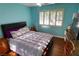 Bedroom with hardwood floors and a window with shutters for natural light at 3132 El Camino Rd, Las Vegas, NV 89146