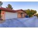Single story home with a large driveway and a two car garage at 3132 El Camino Rd, Las Vegas, NV 89146