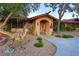 Charming single-story home with tiled roof, stucco exterior, and unique dinosaur statue in the yard at 3132 El Camino Rd, Las Vegas, NV 89146