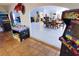 Open-concept game room with classic arcade games and a view of the dining and living spaces at 3132 El Camino Rd, Las Vegas, NV 89146