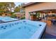 Outdoor oasis featuring dual hot tubs, a tiki hut, and a covered patio with stylish seating and dining areas at 3132 El Camino Rd, Las Vegas, NV 89146