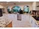 Modern kitchen featuring granite countertops, custom white cabinets, and stainless steel appliances at 3132 El Camino Rd, Las Vegas, NV 89146