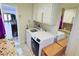 Laundry room with white cabinets, a washing machine, and a dryer at 3132 El Camino Rd, Las Vegas, NV 89146