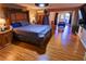 Spacious main bedroom featuring wood floors, a large bed, and a view of the backyard at 3132 El Camino Rd, Las Vegas, NV 89146