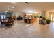 Spacious open floor plan featuring tile floors, a large center island, and dining area at 3132 El Camino Rd, Las Vegas, NV 89146