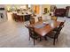 Expansive open floor plan with wood-look tile flooring, a dining area, and a seamless flow throughout at 3132 El Camino Rd, Las Vegas, NV 89146
