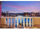 Balcony with a gorgeous view of the water, palm trees, and mountains in the distance at 3173 Lido Isle Ct, Las Vegas, NV 89117