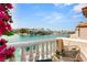 Balcony view overlooking the picturesque waterway with boats, homes, and mountains, showcasing beautiful community setting at 3173 Lido Isle Ct, Las Vegas, NV 89117