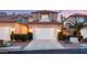 Charming two-story townhome featuring a two-car garage, landscaped front yard, and private balcony above the garage at 3173 Lido Isle Ct, Las Vegas, NV 89117