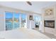 Inviting main bedroom with water views, a fireplace, and a cozy sitting area at 3173 Lido Isle Ct, Las Vegas, NV 89117