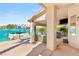 Covered patio features a boat dock, seating area, hot tub, and lake views at 3173 Lido Isle Ct, Las Vegas, NV 89117