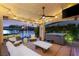 Outdoor living with TV, ceiling fan, lighting, water view, and hot tub at 3173 Lido Isle Ct, Las Vegas, NV 89117