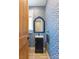 Charming powder room featuring patterned wallpaper, a vanity with mirror, and wood door at 3173 Lido Isle Ct, Las Vegas, NV 89117