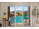 Stunning view of the waterway from a sliding glass door leading to a patio with a dock and boat at 3173 Lido Isle Ct, Las Vegas, NV 89117