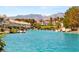 Scenic waterfront community with a turquoise waterway, mountain views and boats docked outside residences at 3173 Lido Isle Ct, Las Vegas, NV 89117