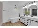 Primary bathroom features a soaking tub, double vanity, modern fixtures, and wood-style floors at 3228 Robin Cir, Las Vegas, NV 89121